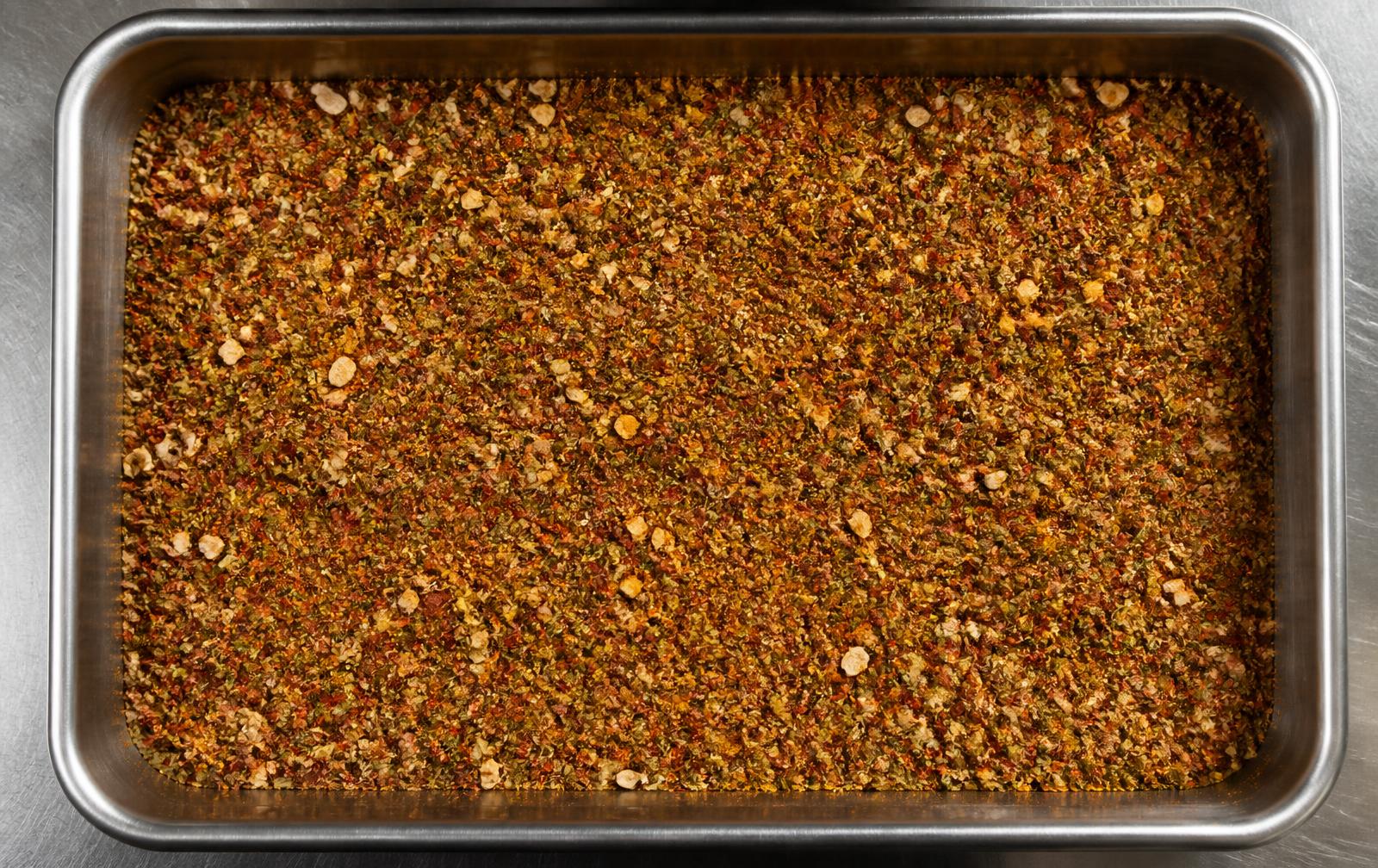 A dry ingredient blend in a stainless steel industrial tray